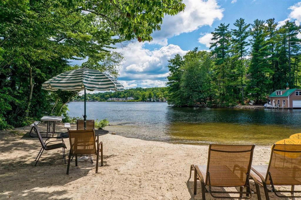 Sandy beach with chairs overlooking Lake Winnipesaukee